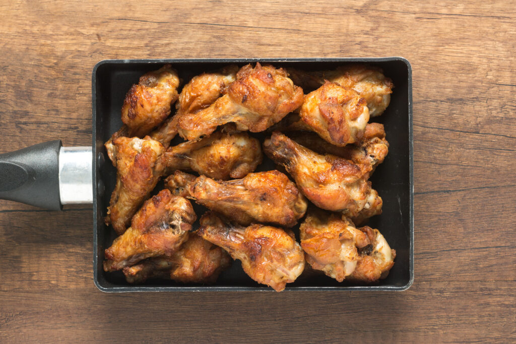 Preparing chicken wings to air fry, showcasing fresh wings being seasoned.