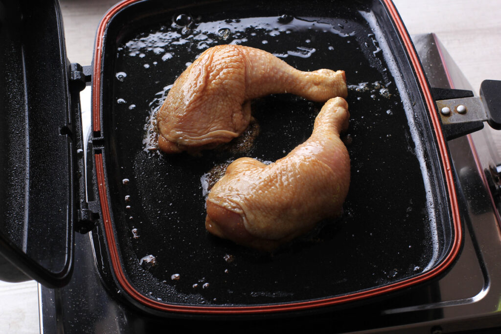 the process of air frying frozen chicken, highlighting the even cooking and browning achieved by the air fryer's hot air circulation.